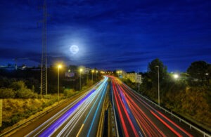 car light trails in a busy motorway on a sunset