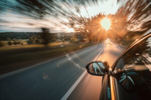 A car driving at dawn on a country road
