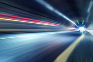 Car lights inside of a tunnel.