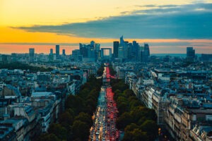 Aerial view of Paris cityscape during evening rush hour along Avenue de la Grande-Armee - view from Arc de Triomphe towards La Defence at sunset.