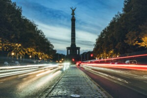 long exposure of rush hour traffic in front of Berlin victory column at sunset in autumn