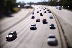 Cars travel in light traffic on the Eastbound 134 freeway in Pasadena California. Cars appear miniaturized.