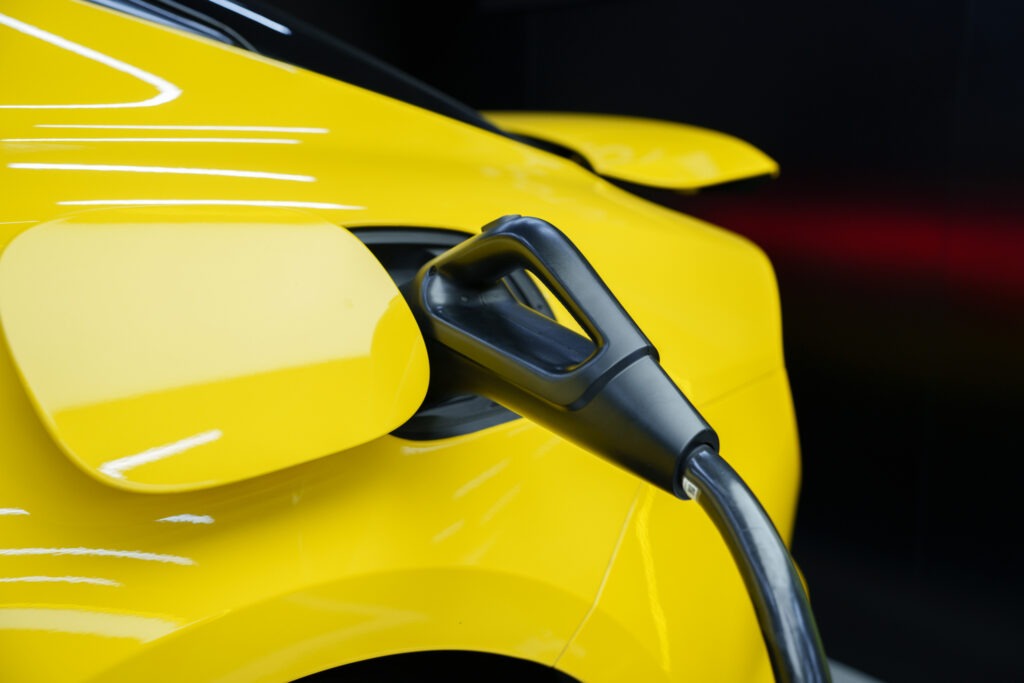 Yellow electric car charging close-up