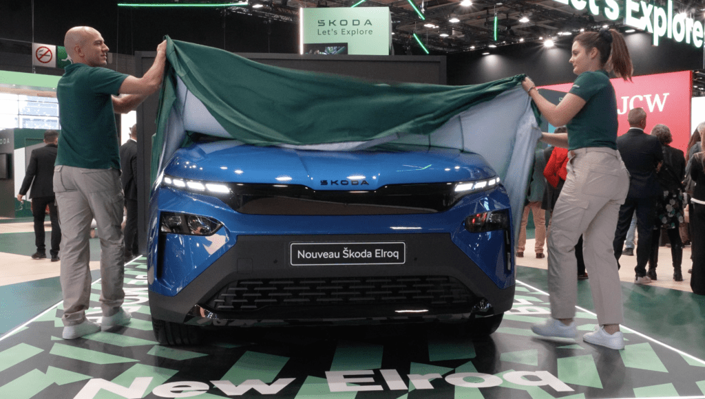 Skoda vehicle being unveiled at a motor show by two people