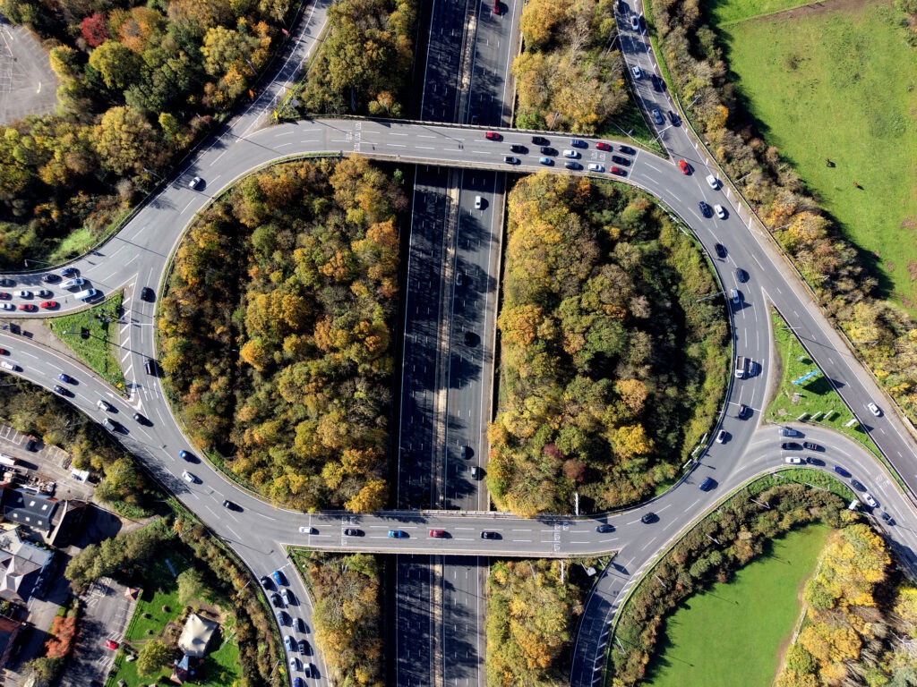 Aerial view over road traffic. Highway and overpass with cars and trucks, interchange, two-level road junction.