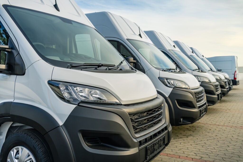 Commercial delivery vans parking in a row, transporting and shipping service company