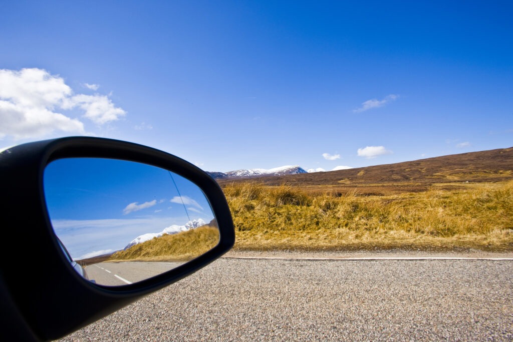 picture of a car wing mirror and a rural landscape in the UK