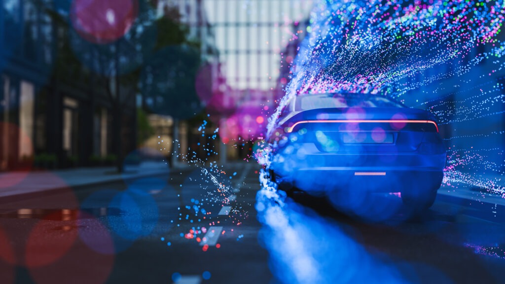A car driving in the city leaving a trail of particles.