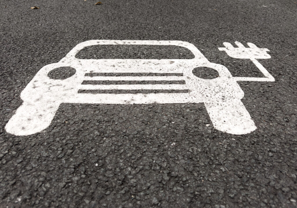 Electric Vehicle Charging Symbol Sign Painted on Asphalt, Wales, United Kingdom