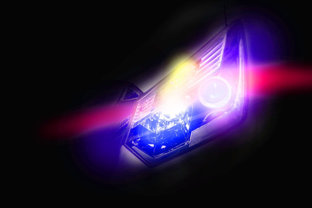 Close up of a car headlight showing a bright colour spectrum