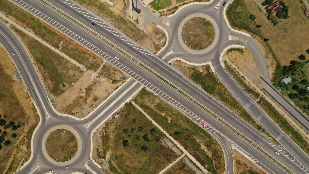 Aerial drone photo of modern motorway roundabouts of Ionia Odos near famous cable bridge of Rio - Antirio Harilaos Trikoupis, Antirio, Greece